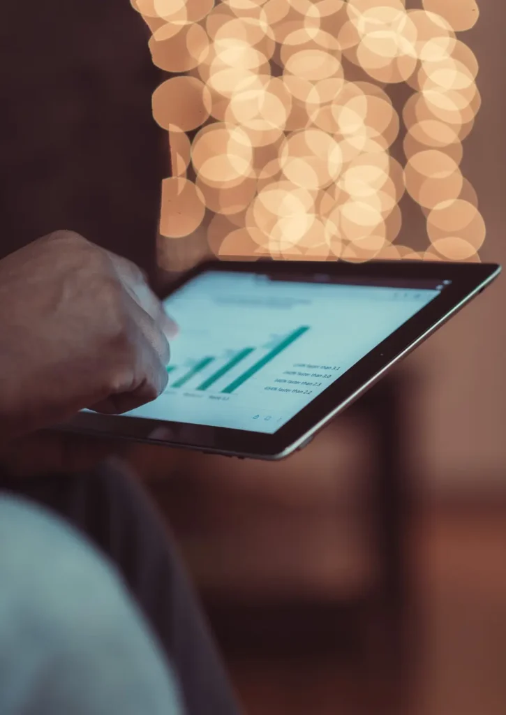 A commercial facility manager using a tablet to monitor HVAC energy efficiency and utility savings in a South Florida office
